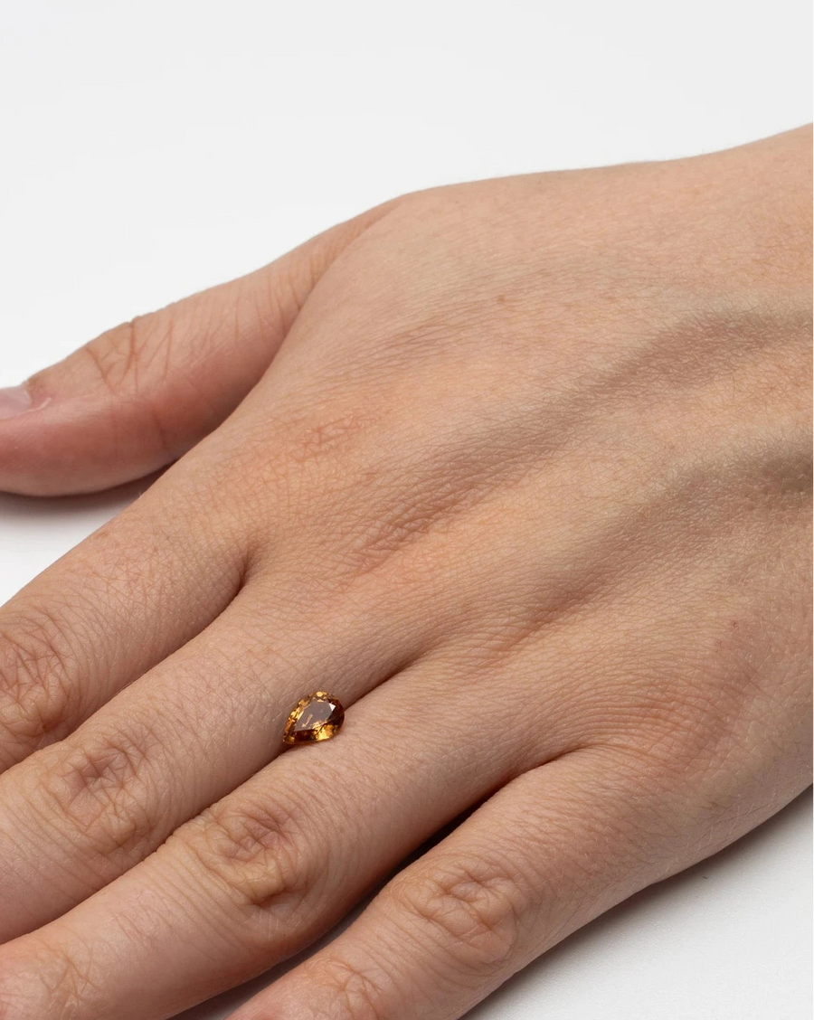 Pierre fine zircon 1,50ct posée à plat sur le dos d'une main pour donner un repère visuel de ses dimensions.